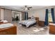 Spacious bedroom with wood-look floors and barn door at 9913 W Pleasant Valley Rd, Sun City, AZ 85351