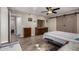 Spacious bedroom with wood-look floors and barn door at 9913 W Pleasant Valley Rd, Sun City, AZ 85351