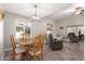 Charming dining area with hardwood floors and a view to the living room at 9913 W Pleasant Valley Rd, Sun City, AZ 85351