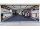 Garage with golf cart, storage shelves, and epoxy floor at 9913 W Pleasant Valley Rd, Sun City, AZ 85351