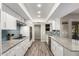 Eat-in kitchen offers granite countertops, white cabinets and stainless steel appliances at 9913 W Pleasant Valley Rd, Sun City, AZ 85351