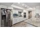 Updated kitchen boasts granite countertops, white cabinets, and stainless steel appliances at 9913 W Pleasant Valley Rd, Sun City, AZ 85351