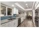 Modern kitchen features granite countertops, white cabinets, and stainless steel appliances at 9913 W Pleasant Valley Rd, Sun City, AZ 85351