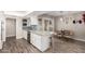 Kitchen with granite countertops, white cabinets, and a breakfast bar at 9913 W Pleasant Valley Rd, Sun City, AZ 85351