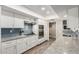 Bright kitchen with granite countertops, white cabinets, and stainless steel appliances at 9913 W Pleasant Valley Rd, Sun City, AZ 85351