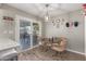 Eat-in kitchen with glass table and chairs, and backyard access at 9913 W Pleasant Valley Rd, Sun City, AZ 85351