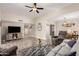 Bright living room with hardwood floors, comfortable seating, and large windows at 9913 W Pleasant Valley Rd, Sun City, AZ 85351
