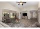 Living room with hardwood floors and a large TV at 9913 W Pleasant Valley Rd, Sun City, AZ 85351
