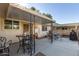 Covered patio with seating area and grill at 9913 W Pleasant Valley Rd, Sun City, AZ 85351