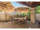 Covered patio with dining table, chairs, and umbrellas, creating an outdoor oasis at 2043 W Nopal Ave, Mesa, AZ 85202