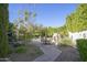 Landscaped backyard with brick pathway, leading to a patio and fire pit at 26702 N 97Th Ln, Peoria, AZ 85383