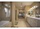 Elegant bathroom with double vanity, soaking tub, and walk-in shower at 26702 N 97Th Ln, Peoria, AZ 85383