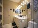 Double vanity bathroom with a large mirror and glass enclosed shower at 26702 N 97Th Ln, Peoria, AZ 85383