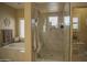 Spa-like bathroom with a large shower, soaking tub, and neutral tile at 26702 N 97Th Ln, Peoria, AZ 85383