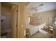 Bedroom with a queen bed, access to bathroom, and plenty of natural light at 26702 N 97Th Ln, Peoria, AZ 85383