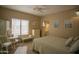 Bright bedroom with a queen-size bed, built-in dresser, and window seating at 26702 N 97Th Ln, Peoria, AZ 85383