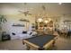 Bright and airy game room featuring a pool table and sectional sofa at 26702 N 97Th Ln, Peoria, AZ 85383