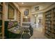 Game room features built-in shelving, a slot machine, and ample space for entertainment at 26702 N 97Th Ln, Peoria, AZ 85383