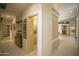 A light and spacious hallway with access to a powder room and other rooms at 26702 N 97Th Ln, Peoria, AZ 85383