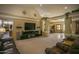 Living room with large TV, leather furniture, and high ceilings at 26702 N 97Th Ln, Peoria, AZ 85383