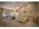 Spacious main bedroom with sitting area, large bed, and access to the bathroom at 26702 N 97Th Ln, Peoria, AZ 85383
