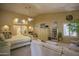 Main bedroom with sitting area, king-size bed, and built-in shelving at 26702 N 97Th Ln, Peoria, AZ 85383