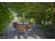 Small patio seating area under a large tree with shade at 26702 N 97Th Ln, Peoria, AZ 85383