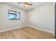 Bedroom with large window and light hardwood floors at 3125 N 86Th Pl, Scottsdale, AZ 85251