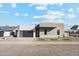 Contemporary home exterior featuring a two-car garage and drought-tolerant landscaping at 3125 N 86Th Pl, Scottsdale, AZ 85251