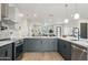 Modern kitchen with gray cabinets, marble backsplash, and stainless steel appliances at 3125 N 86Th Pl, Scottsdale, AZ 85251