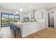 Modern kitchen with white cabinets, marble backsplash, and island at 3125 N 86Th Pl, Scottsdale, AZ 85251