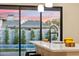 Kitchen island with sink and a view of the backyard pool at 3125 N 86Th Pl, Scottsdale, AZ 85251