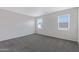 Spacious bedroom with neutral carpeting and two windows at 381 N 20Th St, Coolidge, AZ 85128