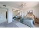 Bright bedroom with mirrored closet doors and ceiling fan at 7820 E Camelback Rd # 209, Scottsdale, AZ 85251