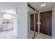 Bright entryway with mirrored closet and kitchen view at 7820 E Camelback Rd # 209, Scottsdale, AZ 85251