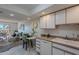 Kitchen with white cabinets, stainless steel appliances, and a view to the living room at 7820 E Camelback Rd # 209, Scottsdale, AZ 85251
