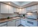 Modern kitchen with white cabinets, updated appliances, and stylish backsplash at 7820 E Camelback Rd # 209, Scottsdale, AZ 85251
