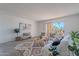 Spacious living area featuring a cozy sofa, stylish decor, and balcony access at 7820 E Camelback Rd # 209, Scottsdale, AZ 85251