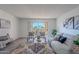 Living room boasts a neutral color palette, plush seating, and views to a private balcony at 7820 E Camelback Rd # 209, Scottsdale, AZ 85251