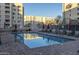 Community pool area with surrounding lounge chairs and patio tables at 7820 E Camelback Rd # 209, Scottsdale, AZ 85251