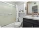 Clean bathroom with a tub shower combo and dark vanity at 10213 W Kingswood Cir, Sun City, AZ 85351