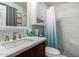 Bathroom with a shower/tub combo and updated vanity at 10213 W Kingswood Cir, Sun City, AZ 85351