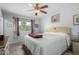 Main bedroom with a queen-size bed and ceiling fan at 10213 W Kingswood Cir, Sun City, AZ 85351