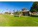Rear view of the house with a green lawn at 10213 W Kingswood Cir, Sun City, AZ 85351