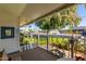Covered porch with wrought iron gate and neighborhood view at 10213 W Kingswood Cir, Sun City, AZ 85351