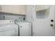 Laundry room with washer, dryer, and built-in cabinets at 10213 W Kingswood Cir, Sun City, AZ 85351