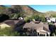 Aerial view of house with pool, tile roof and mountain backdrop at 25995 N 85Th Dr, Peoria, AZ 85383