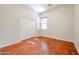 Well-lit bedroom featuring hardwood floors and a double door closet at 25995 N 85Th Dr, Peoria, AZ 85383