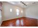 Hardwood floor bedroom with large window and blinds at 25995 N 85Th Dr, Peoria, AZ 85383