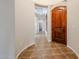 Bright entryway with tile flooring and a wooden door at 25995 N 85Th Dr, Peoria, AZ 85383